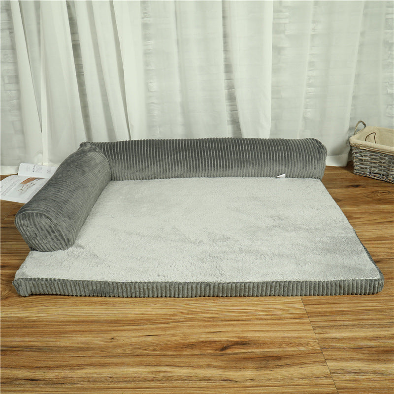 Gray pet bed on a wooden floor with white curtains in the background